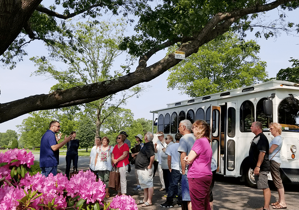 People listening to expert outside of trolly at 3rd annual arboretum tour