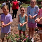 Group of children with hand full of ladybugs