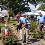 child being handed ladybugs