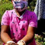 young girl with handful of ladybugs