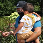 young boy and father with handful of ladybugs
