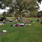 people laying on their yoga mats outside
