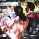 family looking at honey bees