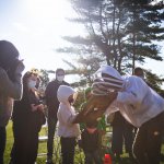 bee keeper showing people bees
