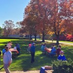 people walking around with fall foliage