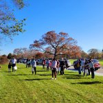 people with fall foliage trees in the background