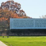 John Donne memorial with fall foliage in background