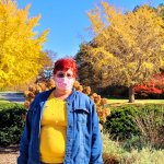 woman standing in front of various fall foliage