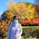 woman standing in front of autumn foliage