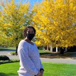 gift standing in front of yellow and green tree
