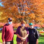 people standing in front of autumn tree