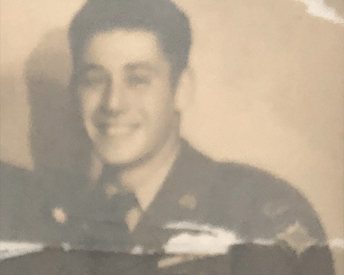 black and white photo of veteran posing in military uniform