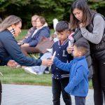 woman handing family a candle