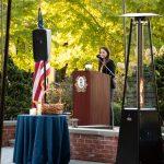 speaking at podium outside