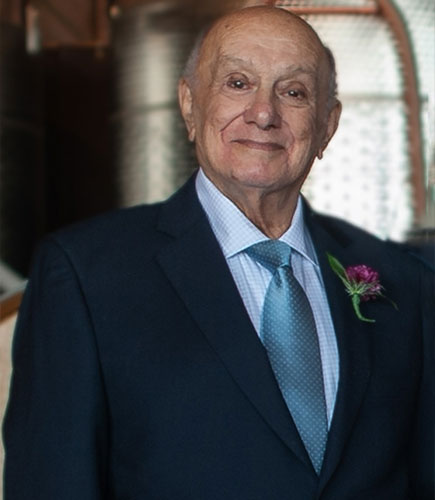 photo of elderly man posing in suit and tie