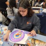 woman creating art project with crayons