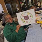 woman holding up finish art project