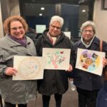 three woman holding up finished art project