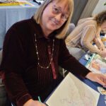 woman smiling working on art project