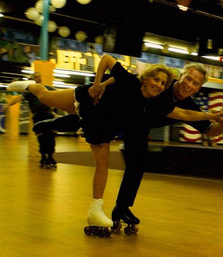 young couple roller blading together in a pose