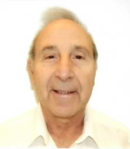 Older man smiling in front of white background