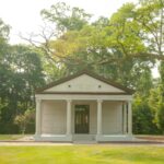 Photo of a mausoleum building surrounded by trees