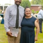 Man and woman posing for a picture in formal wear outside