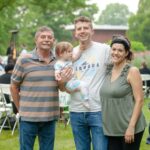 family posing for a picture together mother father child and grandpa