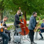 jazz band performing together near an American glaf