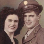 Old photo of a military man in uniform posing with his wife