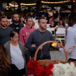 young man walking woman holding a candle