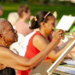 women painting on a canvas