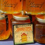 jars of honey labeled Pinelawn Memorial Park stacked on top of each other