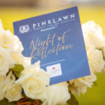 Pinelawn Night of Reflection Pamphlet in a bouquet of flowers