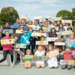 group of children posing with art project outside
